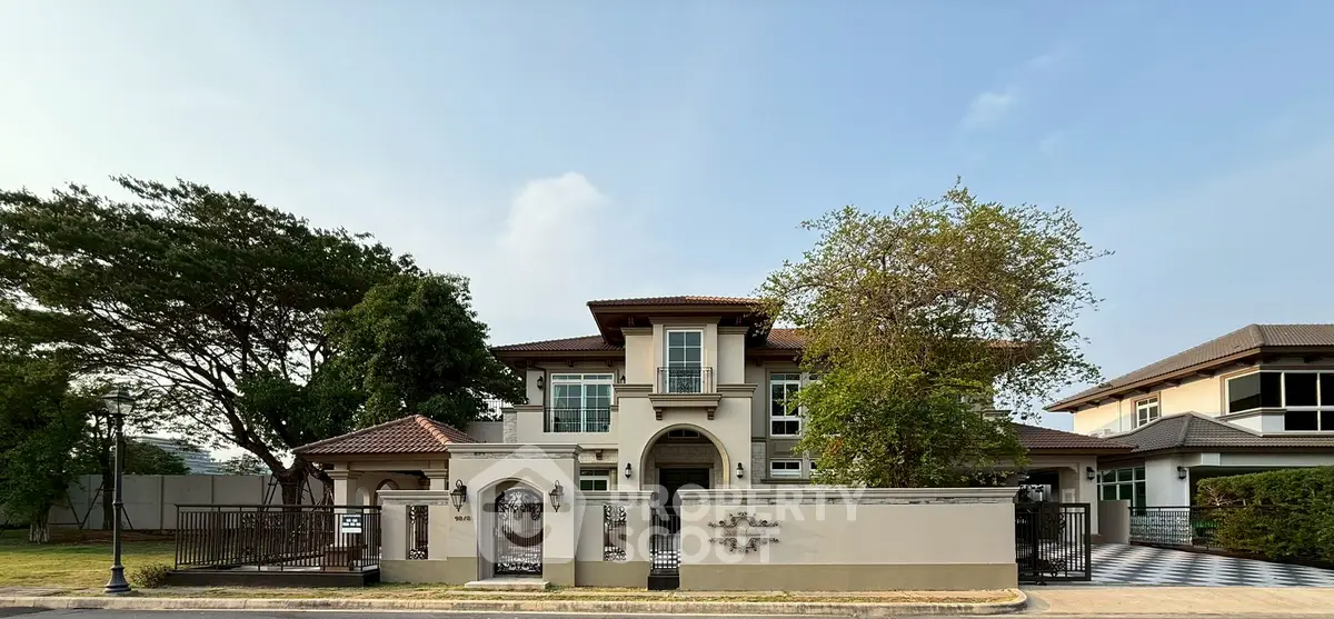 Luxurious two-story villa with elegant facade and lush greenery, perfect for upscale living.