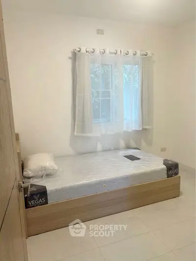 Cozy minimalist bedroom with single bed and natural light