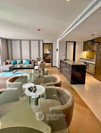 Luxurious open-plan living room with modern kitchen and elegant dining area.