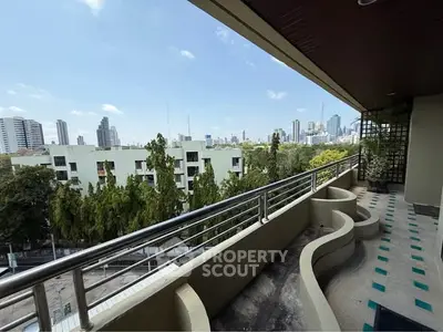 Spacious balcony with stunning city skyline view, perfect for relaxation and entertainment.