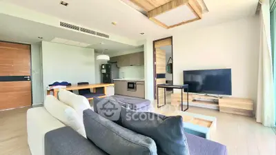 Modern living room with open kitchen and stylish decor in a bright apartment.