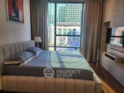 Luxurious bedroom with modern decor and stunning city view through large windows.