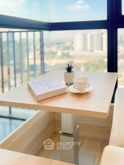 Modern balcony with city view, stylish table, and cozy decor