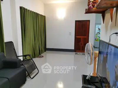 Spacious living room with modern decor and green curtains