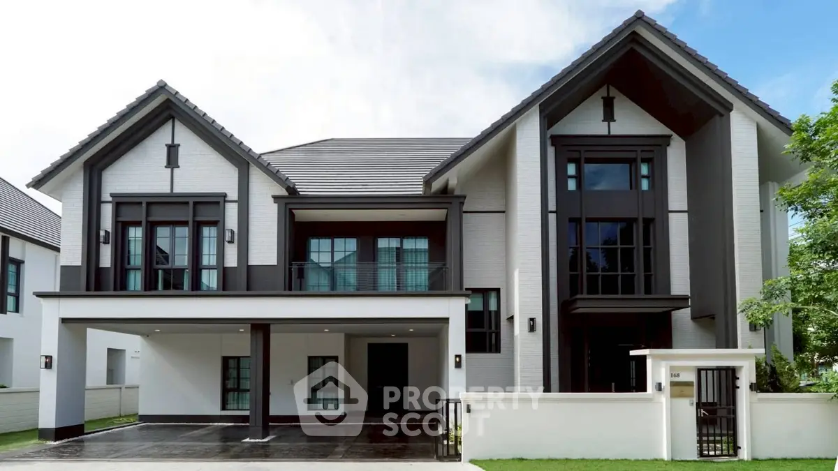 Stunning modern two-story house with sleek design and spacious driveway, perfect for luxurious living.