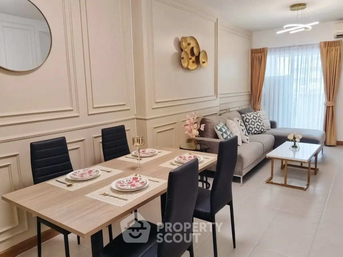 Elegant living room with modern dining area and stylish decor