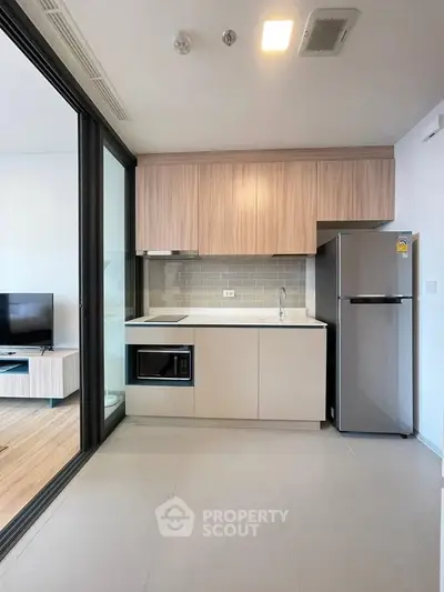 Modern kitchen with sleek appliances and open layout in a stylish apartment.