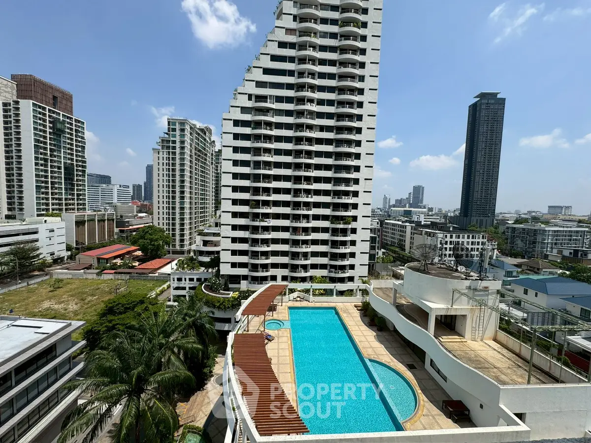 Stunning high-rise building with rooftop pool and city skyline view, perfect for luxury urban living.