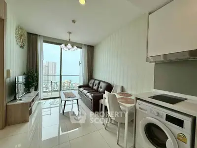 Modern living room with balcony view, sleek furniture, and integrated kitchen appliances.