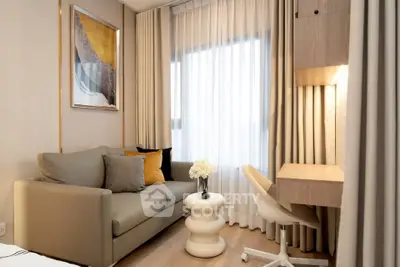 Modern living room with stylish sofa, desk, and elegant decor in a cozy apartment.