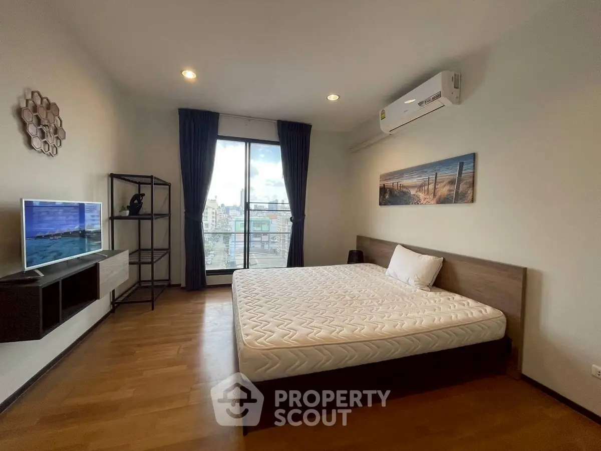 Spacious modern bedroom with city view and stylish decor