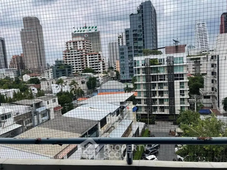 Stunning cityscape view from a high-rise balcony, showcasing urban living.