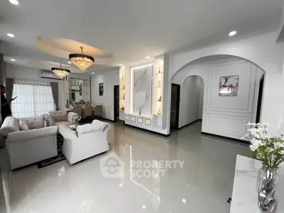 Luxurious open living room with elegant chandeliers and plush seating