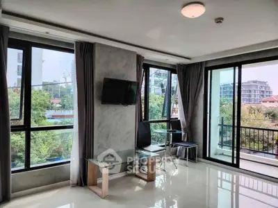 Modern living room with large windows and balcony view