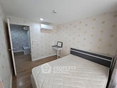 Cozy bedroom with modern decor and air conditioning, perfect for a comfortable living experience.