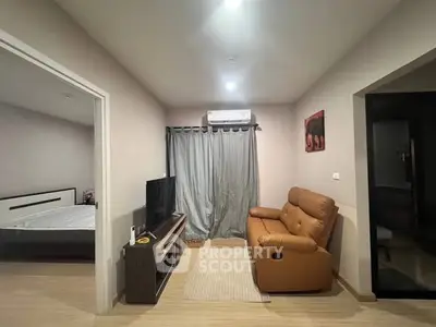 Cozy living room with modern furniture and natural light, perfect for relaxation.