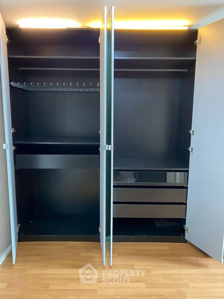 Spacious modern wardrobe with sleek design and ample storage space, perfect for organizing your bedroom essentials.