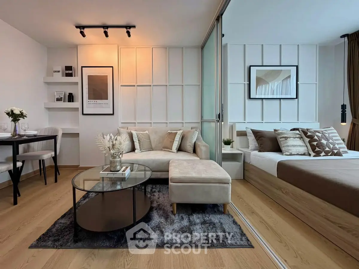Modern open-plan living room and bedroom with stylish decor and cozy ambiance.