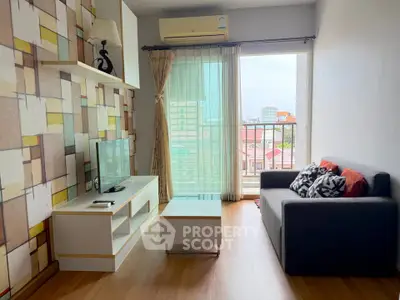 Modern living room with stylish decor and city view balcony in a high-rise apartment.