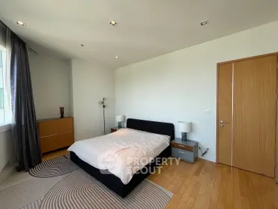 Spacious bedroom with modern decor and natural light