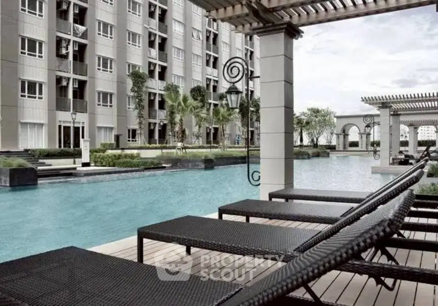 Luxurious apartment complex with stunning poolside view and modern architecture.