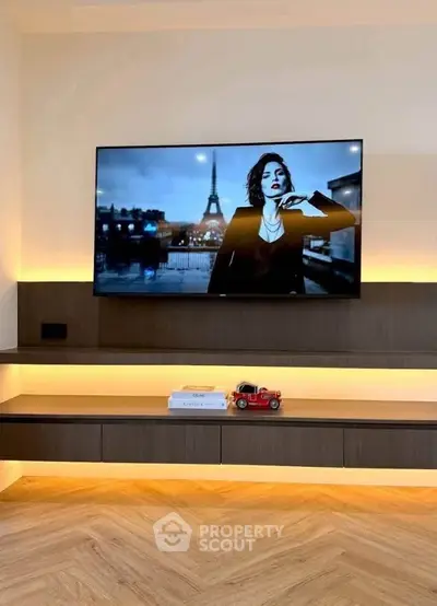 Modern living room with mounted TV and stylish lighting