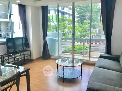 Bright living room with large windows and modern furniture, offering a cozy and inviting atmosphere.