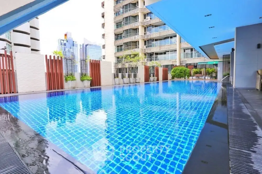 Luxurious high-rise apartment with stunning rooftop pool and city views.