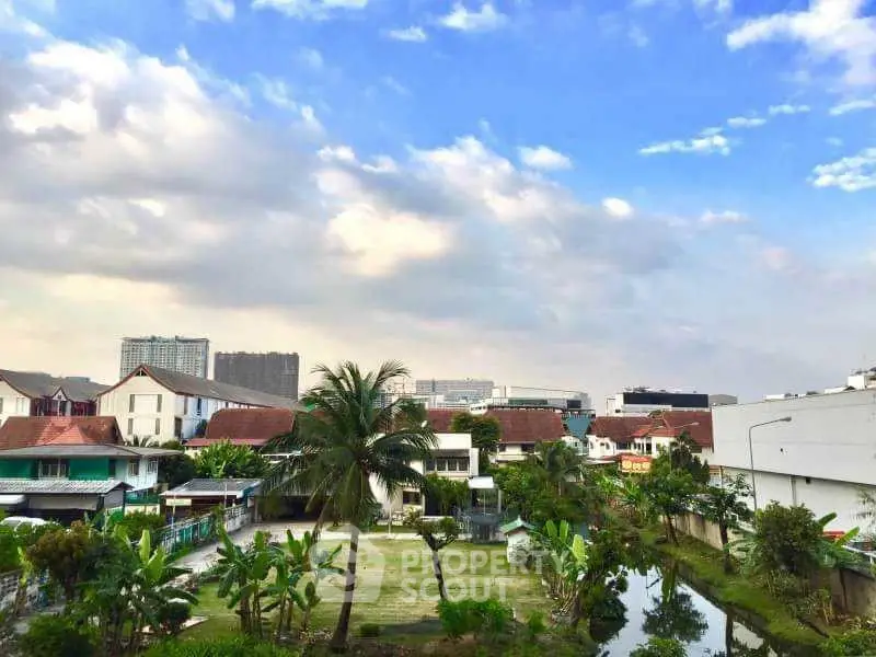 Scenic view of suburban neighborhood with lush greenery and clear blue sky.