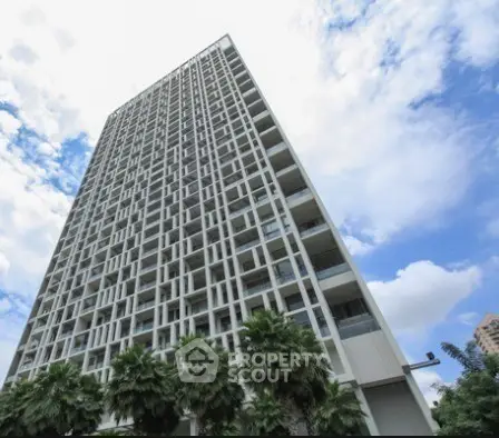 Stunning high-rise building with modern architecture against a vibrant sky.