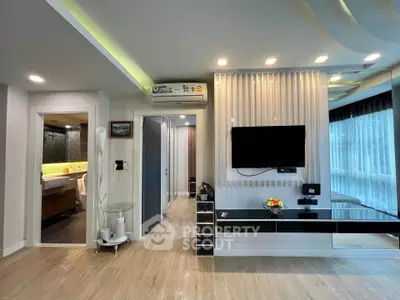 Modern living room with stylish decor and large windows offering natural light.
