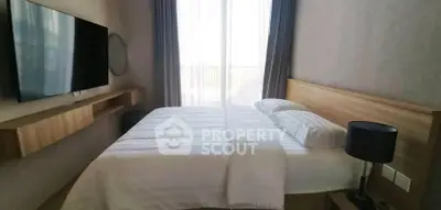 Modern bedroom with large window and wall-mounted TV, featuring elegant decor.