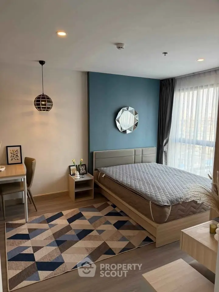 Modern bedroom with stylish decor and ample natural light in a contemporary apartment.