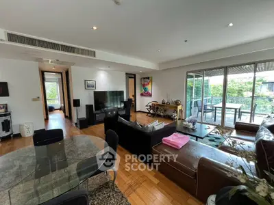 Spacious living room with modern decor and large balcony view