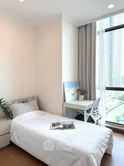 Modern bedroom with city view, featuring a cozy single bed and a sleek desk by the window.