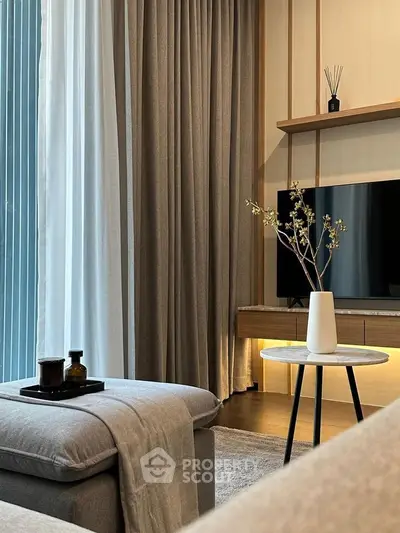 Elegant living room with modern decor, featuring a cozy sofa, stylish coffee table, and large window with curtains.