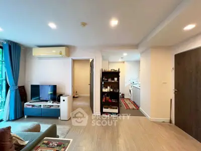 Spacious living room with modern decor and open kitchen layout