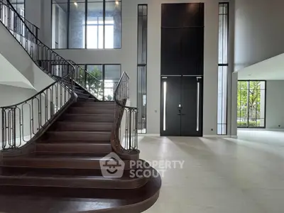 Luxurious grand entrance with elegant staircase and modern design