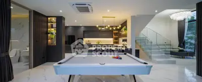Luxurious open-plan living space with pool table and modern kitchen