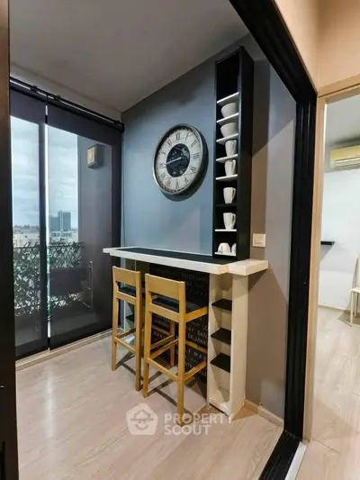 Stylish modern kitchen nook with bar seating and city view, perfect for urban living.