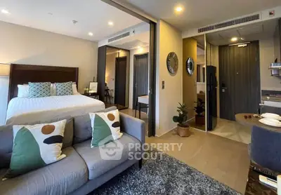 Modern studio apartment with stylish decor and open layout, featuring a cozy living area and comfortable bed.