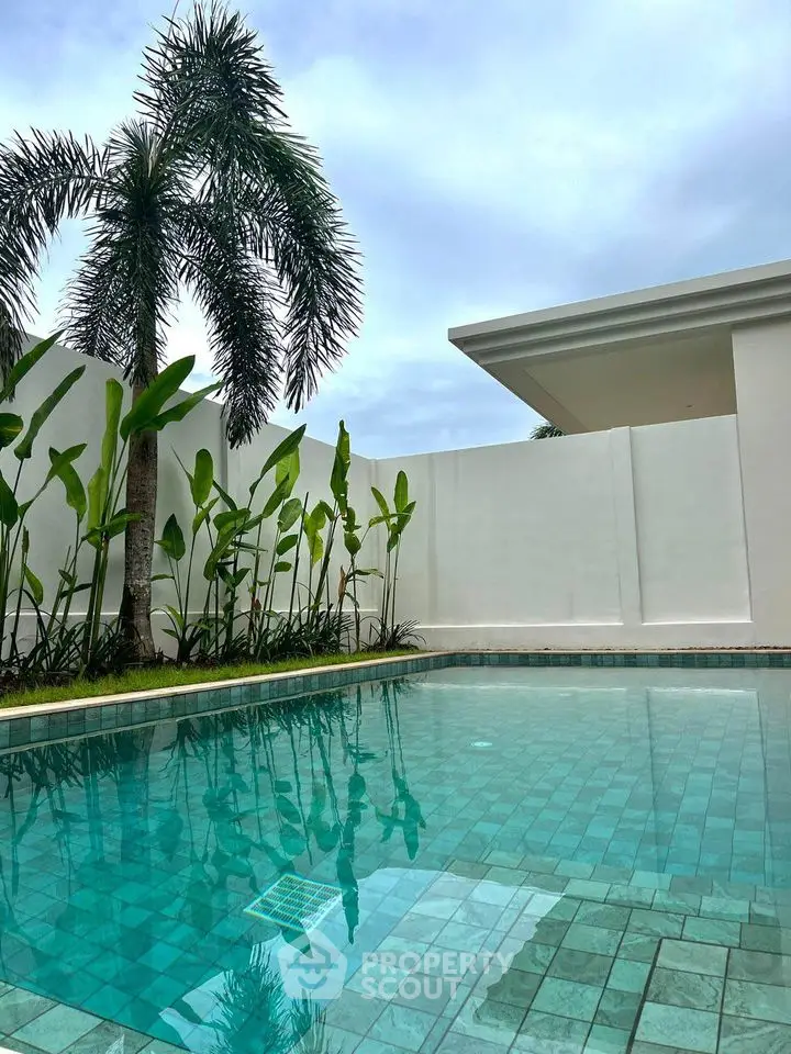 Luxurious private pool with tropical landscaping and modern architecture