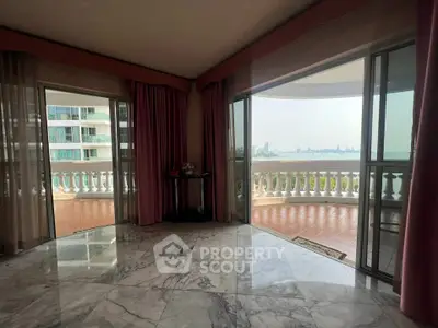 Luxurious living room with marble floors and expansive balcony view