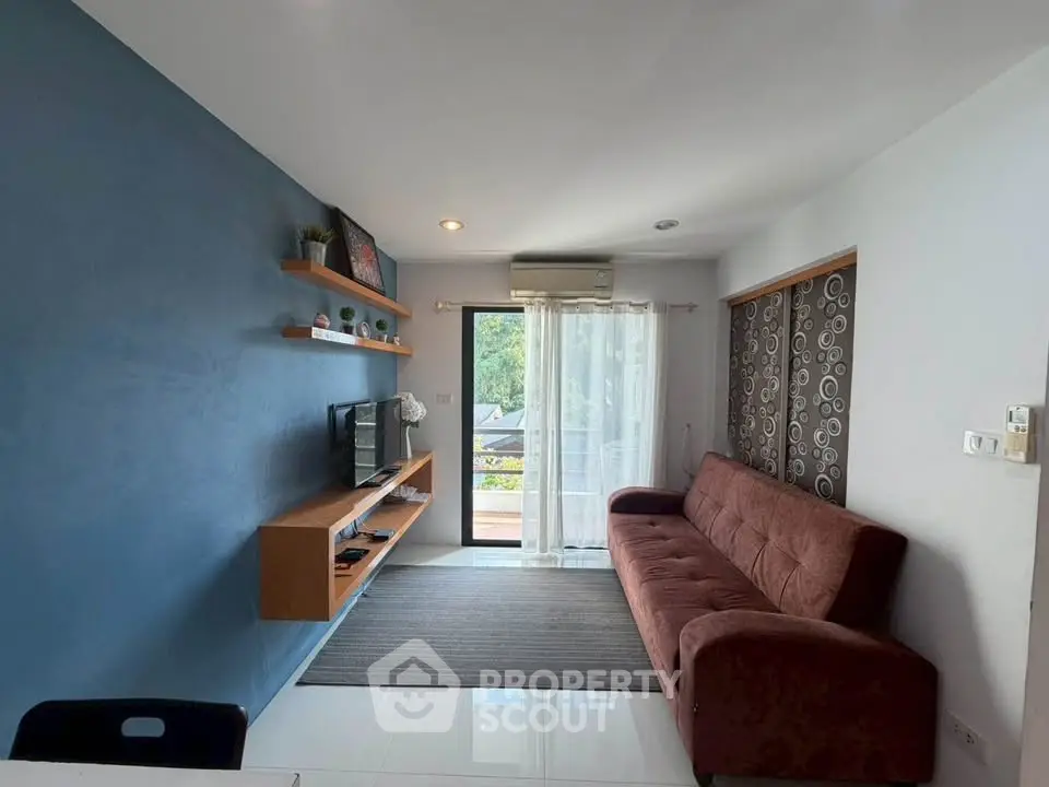 Modern living room with blue accent wall and cozy brown sofa