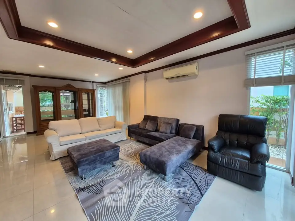 Spacious living room with modern furniture and large windows for natural light.