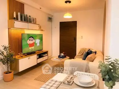 Cozy living room with modern decor, wall-mounted TV, and stylish furniture, perfect for relaxation and entertainment.
