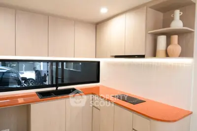 Modern kitchen with sleek cabinetry and vibrant orange countertop