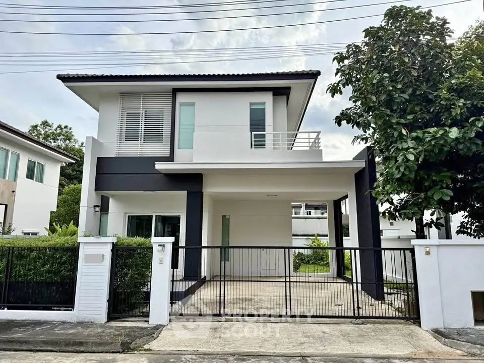 Modern two-story house with sleek design and spacious driveway in a serene neighborhood.