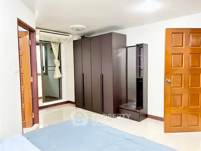 Spacious bedroom with modern wardrobe and air conditioning