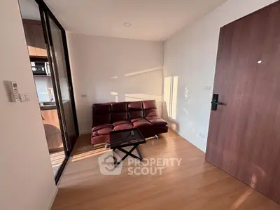 Modern living room with sleek glass door and stylish sofa in a cozy apartment